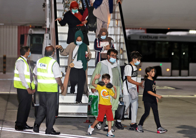 Evacuees from Afghanistan arrive at Hamad International Airport in Qatar's capital Doha on September 10, 2021. (AFP)
