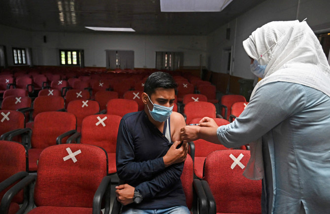  A health worker inoculates a man with a dose of Covishield vaccine against the Covid-19 coronavirus at a vaccination centre in Srinagar on September 17, 2021. (AFP)