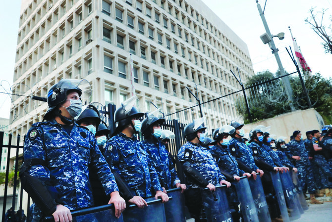 Lebanese police stand guard in front of the central bank building, where anti-government demonstrators protest against the deepening financial crisis, in Beirut. (AP/File)