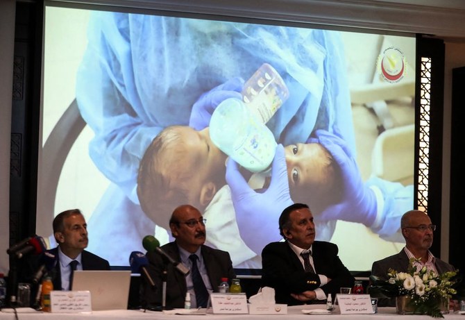 Members of a Jordanian medical team made the announcement during a press conference in Amman on Oct. 3, 2021. In the background, a screen shows the twins before their separation. (AFP)
