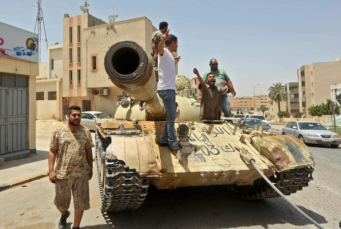 Fighters loyal to Libya's UN-recognised Government of National Accord (GNA) stand atop a tank in the town of Tarhuna, about 65 kilometres southeast of the capital Tripoli on June 5, 2020. (AFP/File Photo)