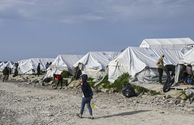 A child walks past tents inside the refugee camp of Kara Tepe in Mytilene, Lesbos. The island of Lesbos hosts more than 8,000 asylum seekers. (File/AFP)