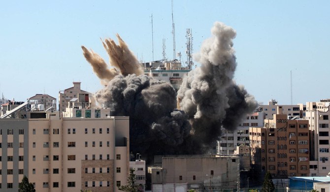 Smoke rising from the Al-Jalaa Tower in Gaza City as it is destroyed by an Israeli airstrike, May 15, 2021. (AFP/File Photo)