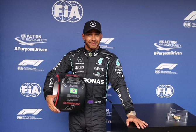 Mercedes’ British driver Lewis Hamilton poses after winning the qualifying session for Brazil’s Formula One Sao Paulo Grand Prix. (AFP)