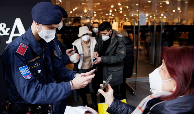 Police officers check the vaccination status of shoppers against the coronavirus disease (COVID-19) at the entrance of a store in Vienna, Austria, November 16, 2021. (REUTERS)
