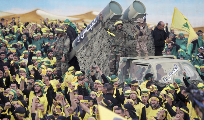 Hezbollah fighters stand atop a truck mounted with mock rockets during a rally in Nabatiyeh, Lebanon. (AP file photo)