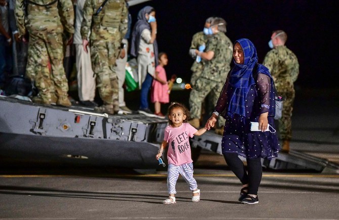 In this handout image courtesy of the US Navy, Afghan evacuees disembark a US Air Force C-17 Globemaster III at Naval Air Station Sigonella, Sicily, Italy on August 22, 2021. (AFP/File Photo)