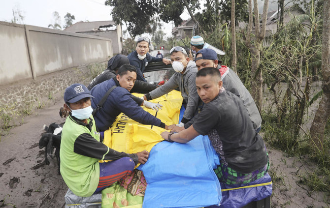 Indonesian rescuers and villagers evacuate a victim on a car in an area affected by the eruption of Mount Semeru in Lumajang, East Java, Indonesia, Sunday, Dec. 5, 2021. (AP)