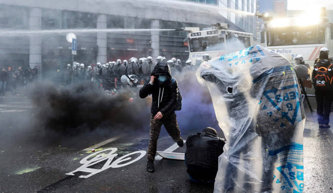 Police use water canons to disperse demonstrators during a demonstration against Belgian government's measures to curb the spread of the Covid-19 and mandatory vaccination in Brussels on December 5, 2021. (AFP)