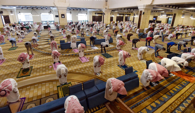 In this file photo taken on May 31, 2020, Muslim worshippers observe a safe distance as they perform noon prayer at Al-Rajhi mosque in the capital Riyadh. (AFP)