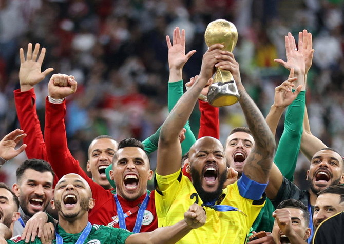 Algeria’s goalkeeper Rais Mbolhi lifts the trophy as they celebrate winning the Arab Cup Final against Tunisia at Al Bayt Stadium in Qatar on Saturday. (Reuters)