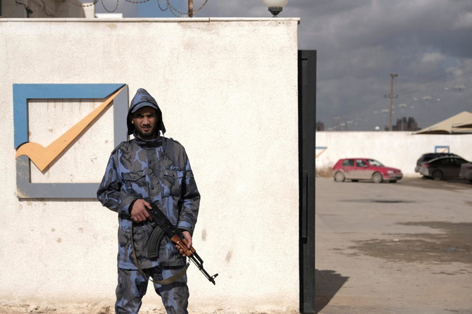A security officer stands in front of the High National Election Commission building in Benghazi, Libya December 16, 2021. (Reuters)