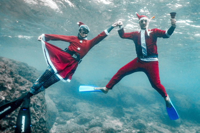Freedivers dressed in Santa Claus costumes pose for a picture while submerged under water off the coast of Lebanon’s northern city of Batroun on Friday. (AFP)