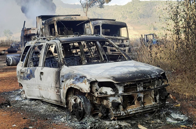 In this photo provided by the Karenni Nationalities Defense Force (KNDF), vehicles smolder in Hpruso township, Kayah state, Myanmar, Friday, Dec. 24, 2021. (AP)