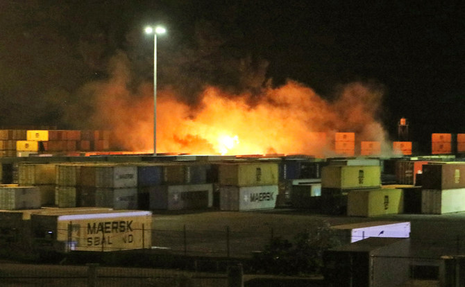 A picture released by the official Syrian Arab News Agency (SANA) on December 7, 2021 shows fire near containers of the Syrian port of Latakia. (AFP)