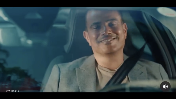 In the commercial for the French car company, Citroen, the Amr Diab is seen tapping his vehicle’s screen to take a photo of a woman crossing the street. (Screenshot)