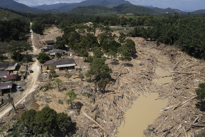 This aerial photos shows piles of logs and debris washed up along a riverside one week after massive flood on the outskirts of Karak town, Pahang state, Malaysia. (AP)