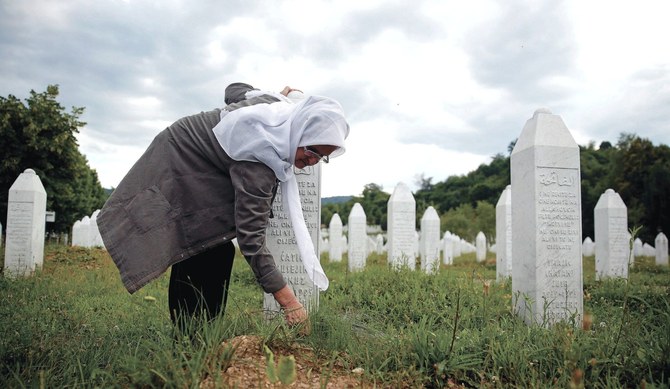 A woman cleaning the grave of her husband near Srebrenica, Bosnia and Herzegovina, in 2015. (Reuters/File Photo)