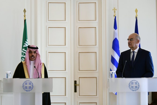 Saudi Foreign Minister Prince Faisal Bin Farhan (L) makes statements with his Greek counterpart Nikos Dendias after their meeting in Athens, Greece, Tuesday, Jan. 4, 2022. (AP)