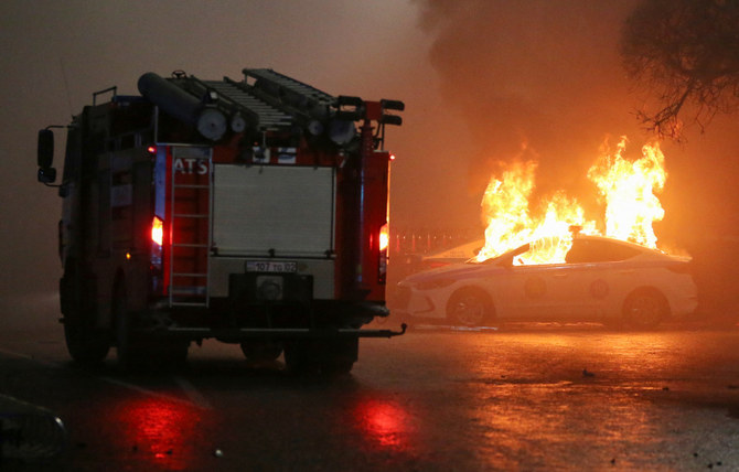 A view shows a burning police car during a protest against LPG cost rise following the Kazakh authorities' decision to lift price caps on liquefied petroleum gas in Almaty, Kazakhstan January 5, 2022. (REUTERS)