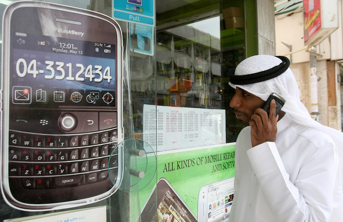 A man walks past a sign advertising the BlackBerry mobile phone at a shopping mall in Dubai on August 1, 2010. (AFP/File Photo)