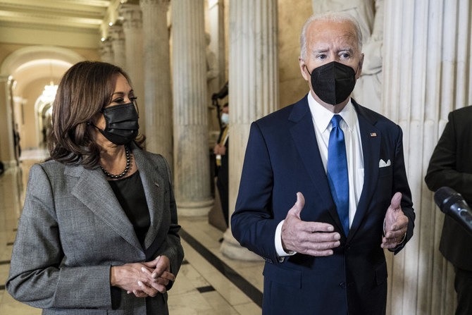 President Joe Biden departs with Vice President Kamala Harris after he spoke in Statuary Hall at the US Capitol to mark the one year anniversary of the Jan. 6 riot by supporters loyal to then-President Donald Trump. (AP)