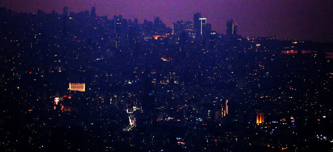 A picture taken on July 27, 2020 shows part of Lebanon’s capital Beirut in the dark caused by fuel shortages. (AFP)