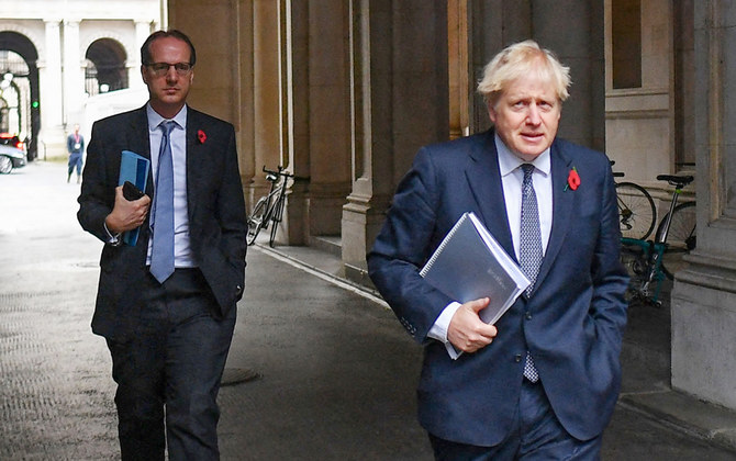 In this file picture taken on November 10, 2020, Britain's Prime Minister Boris Johnson (R) and Martin Reynolds, the Prime Minister's Principal Private Secretary (L), arrive back at Downing Street in London. (AFP)