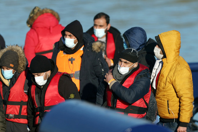 Migrants arrive into the Port of Dover onboard a Border Force vessel after being rescued while crossing the English Channel, in Dover, Britain, January 14, 2022. (REUTERS)