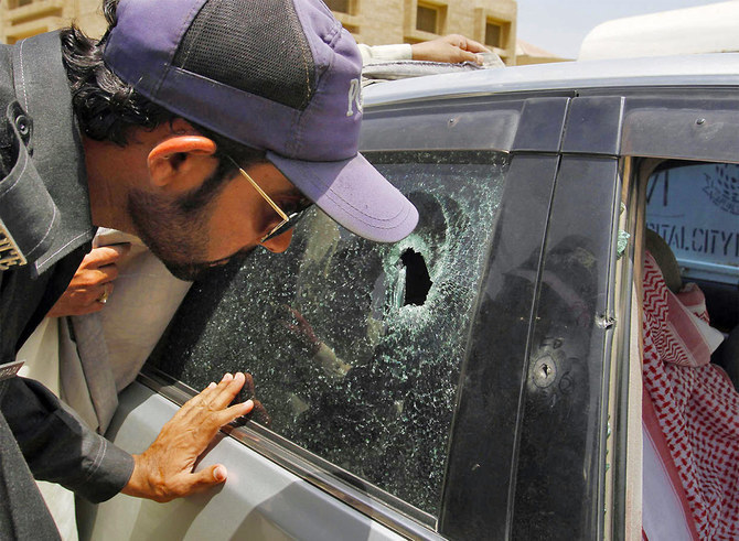 A police officer examines a bullet hole on the car of the Saudi consulate employee who was shot dead in Karachi on May 16, 2011. (AP/File Photo)