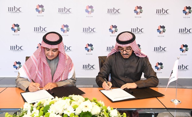 The agreement being signed by representatives from NEOM and MBC Group (Supplied/NEOM)