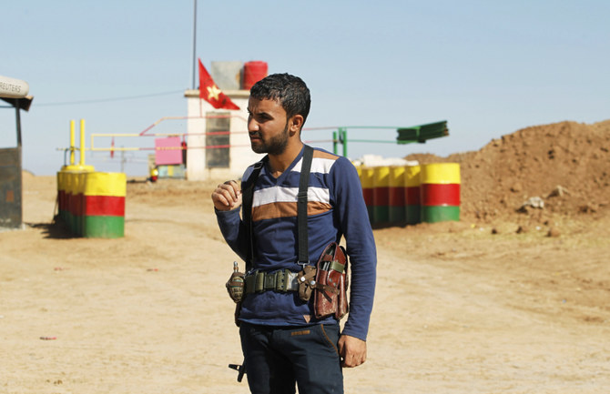 An officer of the Syrian Kurdish Democratic Union Party (PYD) stands guard near the Syrian-Iraq border in this Oct. 31, 2012, photo. (Reuters)