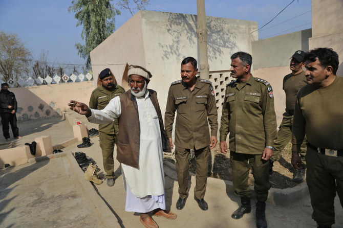 Mian Mohammad Ramzan the mosque custodian gestures as he briefs police officers regarding the stoning to death of Mushtaq Ahmed in Tulamba, eastern Pakistan, Sunday, Feb. 13, 2022. (AP)