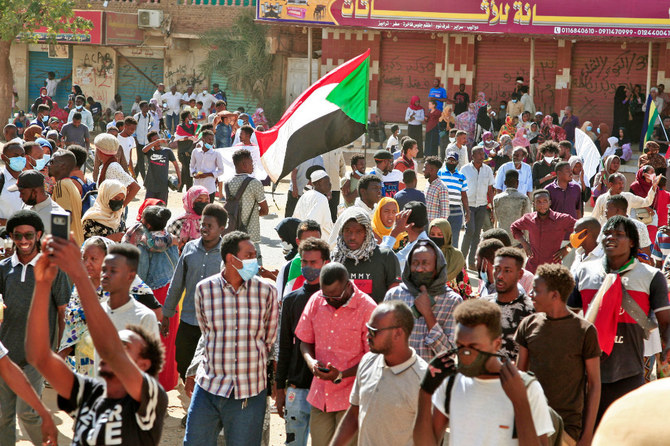 Sudanese protesters march during a demonstration calling for civilian rule and denouncing the military administration, in the capital Khartoum's twin city of Umdurman, on February 14, 2022. (AFP)