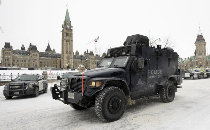An RCMP tactical vehicle drives past the Parliament buildings, Sunday, Feb. 20, 2022 in Ottawa. (AP)