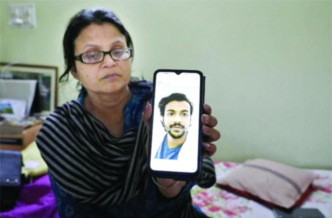 The mother of Pushpak Swarnakar, a medical student at Ukraine’s Ternopil National Medical University, shows a photo of her son. (Reuters)