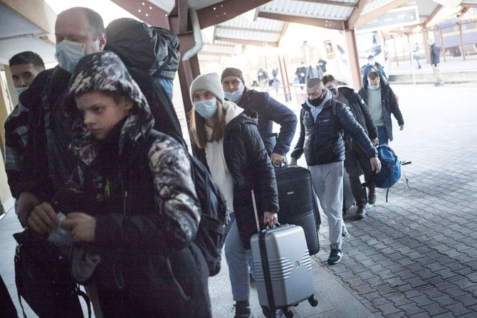People arrive by train from Kharkiv, in the east of Ukraine, in Przemysl, Poland, on Thursday, Feb. 24, 2022. (AP)