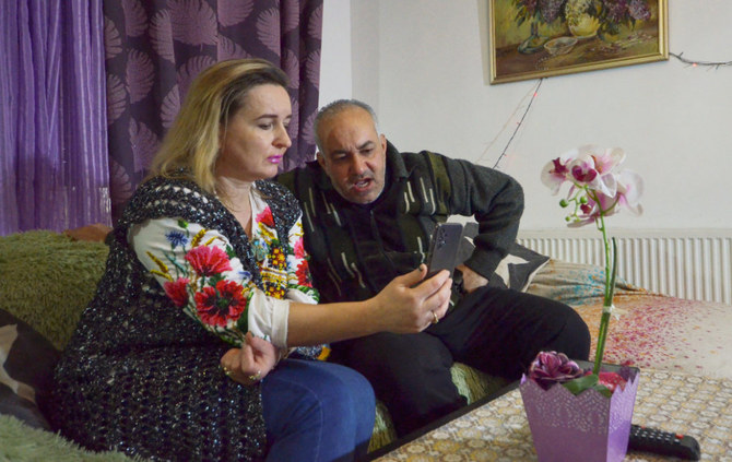 Jordanian student in Ukraine Diana al Awamleh's parents, Wessam al Awamleh and Tatiana al Awamleh, talk to her on the mobile phone in Amman, Jordan February 26, 2022. (REUTERS)