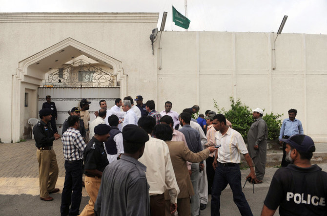 Pakistani security officials gather outside the Saudi consulate in Pakistan's port city of Karachi on May 11, 2011, following a grenade attack. (AFP)