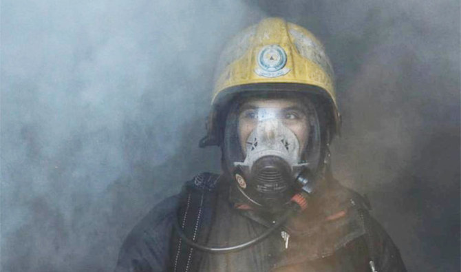 A firefighter from the civil defense team in Hail (northern Saudi Arabia) tries to put out a fire in a factory in October 2020. (Photo/Civil Defense)