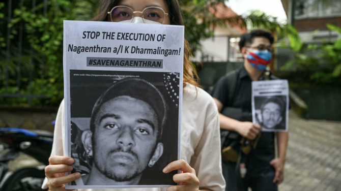 Activists hold placards before submitting a memorandum to parliament in protest of the impending execution of Nagaenthran K. Dharmalingam, sentenced to death for trafficking heroin into Singapore, in Kuala Lumpur. (AFP)