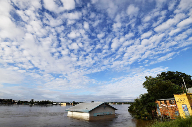 A submerged shed is seen on the bank of the overflowing Clarence River in Grafton, some 130 kms from the New South Wales town Lismore on, March 1, 2022. (AFP)