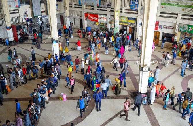 Commuters walk and line up at counters at Kamalapur railway station in the Bangladeshi capital Dhaka. (AFP)