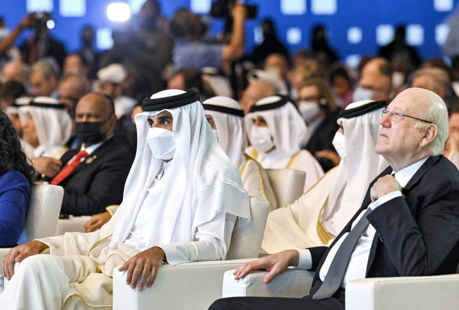 This handout image provided by the Doha Forum shows Qatar's Emir Sheikh Tamim bin Hamad al-Thani (L) and Lebanon's Prime Minister Najib Mikati attending the Doha Forum in Qatar's capital on March 26, 2022. (AFP)