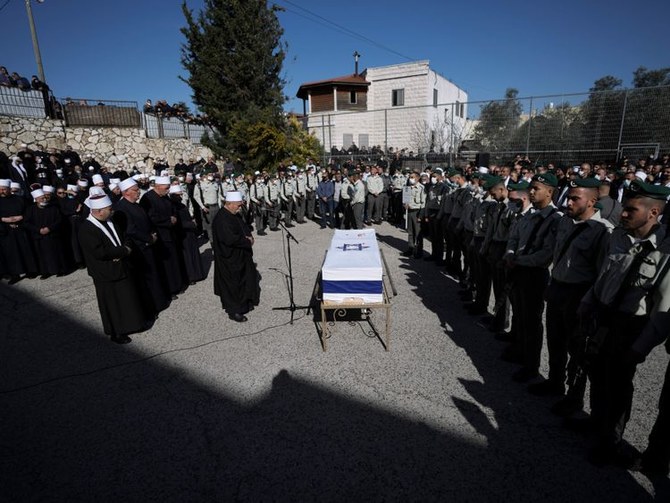 Mourners gather around the flag-draped coffin of Druze Israeli border police officer Yezen Falah, 19, during his funeral in the village of Kisra-Sumei, northern Israel, Monday, March 28, 2022. (AP)