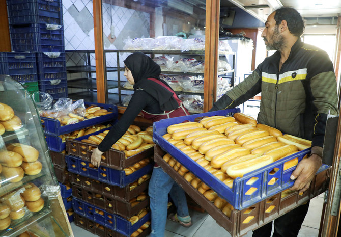 Workers carry boxes of bread loaves at a bakery in Beirut, Lebanon March 29, 2022. Picture taken March 29, 2022. (REUTERS)