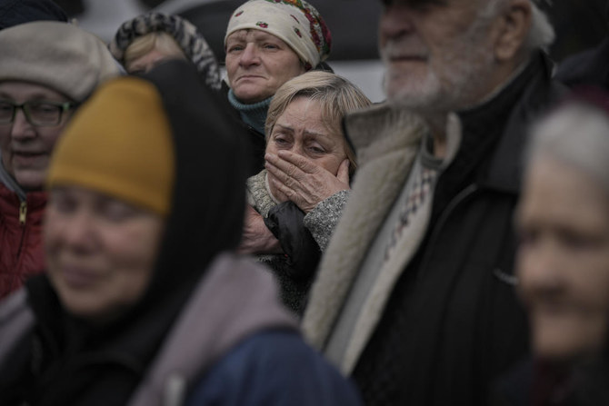 A woman cries as residents listen to a Ukrainian serviceman speaking after a convoy of military and aid vehicles arrived in the formerly Russian-occupied Kyiv suburb of Bucha, Ukraine, April 2, 2022. (AP)