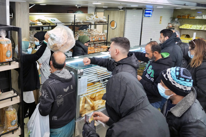 People queue for bread inside a bakery in the southern Beirut suburb of Dahiyeh, Lebanon. (AP file photo)