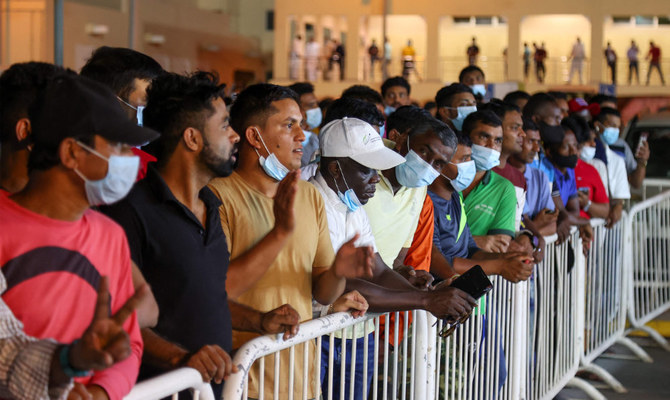 Thousands of laborers in Qatar form long queues for glimpse of World Cup