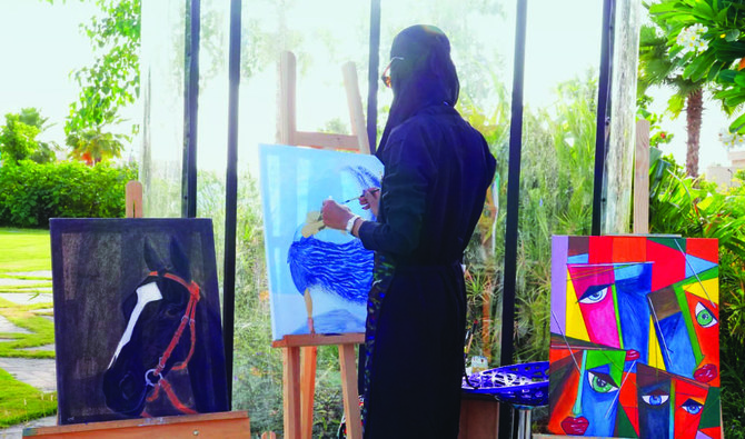 One of Saudi artist Meead Anwar Abulata’s live paintings portrayed a lady in a dress with hues of blue. (AN photo/Huda Bashatah)
